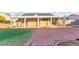 Enjoy outdoor living on the covered patio, overlooking the backyard with turf and brick pavers, and equipped with solar panels at 2315 Opponents Ridge St, North Las Vegas, NV 89032