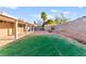 The property features a covered patio, storage sheds, artificial turf, and brick pavers for outdoor enjoyment and convenience at 2315 Opponents Ridge St, North Las Vegas, NV 89032