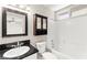 This bathroom features a dark granite counter and a shower-tub combo at 2315 Opponents Ridge St, North Las Vegas, NV 89032