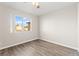 Bedroom features wood-look floors and a window with an outside view at 2315 Opponents Ridge St, North Las Vegas, NV 89032