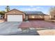 Charming home featuring solar panels, a two-car garage, and a low-maintenance front yard at 2315 Opponents Ridge St, North Las Vegas, NV 89032