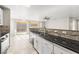 Open kitchen with tile floors, granite countertops, and stainless steel appliances at 2315 Opponents Ridge St, North Las Vegas, NV 89032
