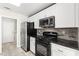 Bright kitchen featuring stainless steel appliances, white cabinetry, and tile backsplash at 2315 Opponents Ridge St, North Las Vegas, NV 89032