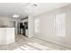 This is a bright kitchen and dining area featuring tile floors, a stylish light fixture, and breakfast bar at 2315 Opponents Ridge St, North Las Vegas, NV 89032