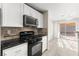 Updated kitchen featuring stainless steel appliances, granite countertops, and tile floors at 2315 Opponents Ridge St, North Las Vegas, NV 89032