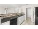 Modern kitchen with stainless steel appliances, tile backsplash, and ample counter space at 2315 Opponents Ridge St, North Las Vegas, NV 89032