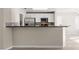 The kitchen has stainless steel appliances and a breakfast bar that opens to the living area at 2315 Opponents Ridge St, North Las Vegas, NV 89032