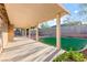 Covered patio provides ample shade and space for outdoor seating and dining with a view of the backyard at 2315 Opponents Ridge St, North Las Vegas, NV 89032