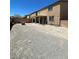 Large gravel backyard, perfect for customization with landscaping at 2409 W Gilmore Ave, North Las Vegas, NV 89032