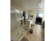 Bathroom with a glass-enclosed shower and neutral tile flooring and view into a bedroom at 2409 W Gilmore Ave, North Las Vegas, NV 89032