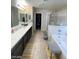 Primary bathroom with double vanity, walk-in shower, and separate soaking tub at 2409 W Gilmore Ave, North Las Vegas, NV 89032