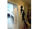 Bathroom view with the bathtub and shower out of focus with a door and personal items hanging on it at 2409 W Gilmore Ave, North Las Vegas, NV 89032