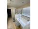 A well lit primary bathroom featuring a walk in shower and soaking tub at 2409 W Gilmore Ave, North Las Vegas, NV 89032