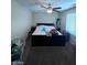 Bright bedroom with ceiling fan and large bed at 2409 W Gilmore Ave, North Las Vegas, NV 89032