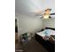 Bedroom with ceiling fan and neutral walls offers a relaxing private space at 2409 W Gilmore Ave, North Las Vegas, NV 89032
