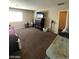 View of carpeted bedroom with lots of items on the floor plus a window, bed, and furnishings at 2409 W Gilmore Ave, North Las Vegas, NV 89032