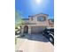 Inviting two-story home featuring desert landscaping, a brick driveway, and a two-car garage at 2409 W Gilmore Ave, North Las Vegas, NV 89032