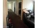 Hallway leading to rooms with dark carpet flooring at 2409 W Gilmore Ave, North Las Vegas, NV 89032