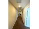 Long hallway with carpet and white doors at 2409 W Gilmore Ave, North Las Vegas, NV 89032