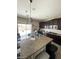 Gourmet kitchen with granite counters, stainless appliances, and large island is perfect for entertaining at 2409 W Gilmore Ave, North Las Vegas, NV 89032