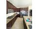 Bright kitchen with stainless appliances, granite counters, and ample storage overlooks the open floor plan at 2409 W Gilmore Ave, North Las Vegas, NV 89032