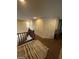 Second floor landing with carpet, railing, and one window at 2409 W Gilmore Ave, North Las Vegas, NV 89032