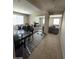 Open-concept living space features dining, living, and Gathering areas filled with natural light from large windows at 2409 W Gilmore Ave, North Las Vegas, NV 89032