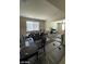 The open-concept living space includes a dining area and living room with large windows for ample light at 2409 W Gilmore Ave, North Las Vegas, NV 89032