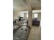 This living space features an open-concept design connecting living, dining, and Gathering areas, tiled and carpeted floors at 2409 W Gilmore Ave, North Las Vegas, NV 89032