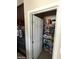Walk-in pantry with door open to reveal ample shelving for storage in a modern home at 2409 W Gilmore Ave, North Las Vegas, NV 89032