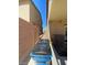 View of the narrow side yard with trashcans next to the home at 2409 W Gilmore Ave, North Las Vegas, NV 89032