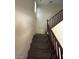 Carpeted staircase with wooden railings ascends to the upper level at 2409 W Gilmore Ave, North Las Vegas, NV 89032
