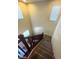 Carpeted staircase with dark brown banister and neutral walls at 2409 W Gilmore Ave, North Las Vegas, NV 89032