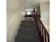 Carpeted staircase with dark wood railing leading to the living area at 2409 W Gilmore Ave, North Las Vegas, NV 89032