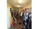 A large walk-in closet with clothes and shelving at 2409 W Gilmore Ave, North Las Vegas, NV 89032