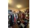 A large walk-in closet with clothes and shelving at 2409 W Gilmore Ave, North Las Vegas, NV 89032