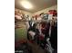 A walk-in closet with clothes hanging on a rod and boxes and stuffed animals on the shelf at 2409 W Gilmore Ave, North Las Vegas, NV 89032