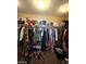 A large walk-in closet with clothes and shelving at 2409 W Gilmore Ave, North Las Vegas, NV 89032