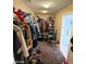 A large walk-in closet with clothes and shelving at 2409 W Gilmore Ave, North Las Vegas, NV 89032