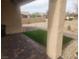 Covered back patio with brick pavers and artificial grass, perfect for outdoor relaxation at 2704 Willow Wren Dr, North Las Vegas, NV 89084