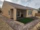 Spacious backyard with covered patio, low-maintenance landscaping, and neutral color scheme at 2704 Willow Wren Dr, North Las Vegas, NV 89084