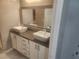 Bathroom featuring a double vanity with modern sinks and a large mirror at 2704 Willow Wren Dr, North Las Vegas, NV 89084