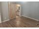 A spacious bedroom with wood-like floors and a barn door entrance to the bathroom at 2704 Willow Wren Dr, North Las Vegas, NV 89084