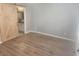 Bedroom with wood floors and sliding barn door to the bathroom at 2704 Willow Wren Dr, North Las Vegas, NV 89084