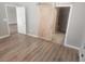 Bedroom featuring wood floors and access to the bathroom via a barn door at 2704 Willow Wren Dr, North Las Vegas, NV 89084