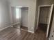 Bedroom boasts wood flooring, a mirrored closet, and neutral wall paint at 2704 Willow Wren Dr, North Las Vegas, NV 89084