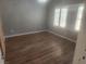 Spacious bedroom with wood floors, neutral paint, and bright shutters at 2704 Willow Wren Dr, North Las Vegas, NV 89084