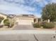 Single-story home featuring a brick driveway, desert landscaping, and solar panels at 2704 Willow Wren Dr, North Las Vegas, NV 89084