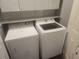 Modern laundry room includes side-by-side washer and dryer at 2704 Willow Wren Dr, North Las Vegas, NV 89084