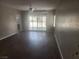 Spacious living room with new hard surface floors, ceiling fan, and lots of light at 2704 Willow Wren Dr, North Las Vegas, NV 89084